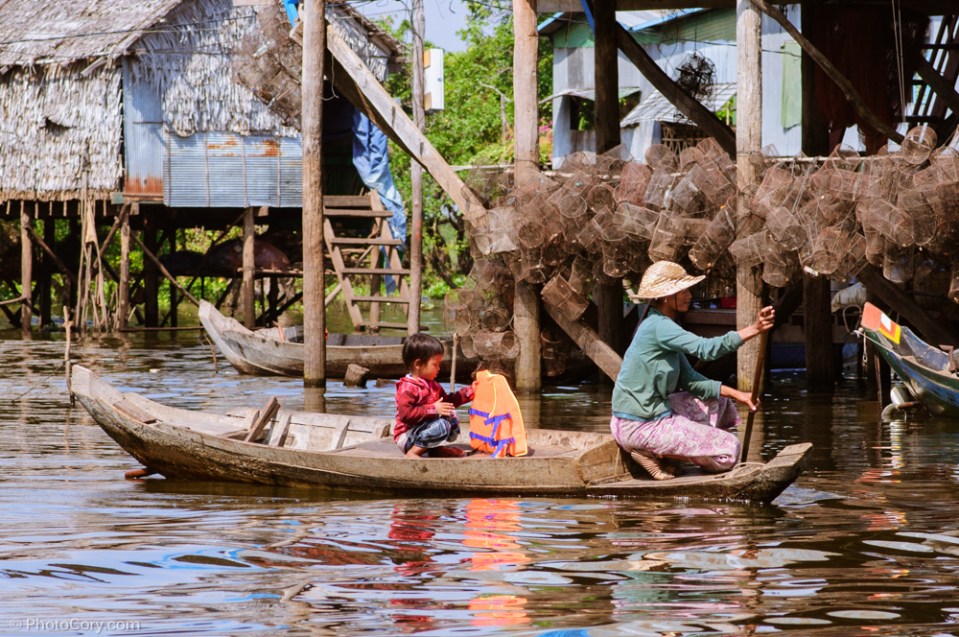 people on boat Floating village cambodia