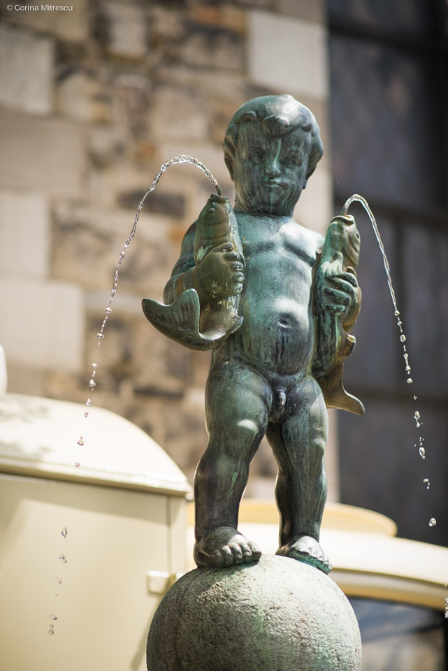 statue boy fish aachen germany