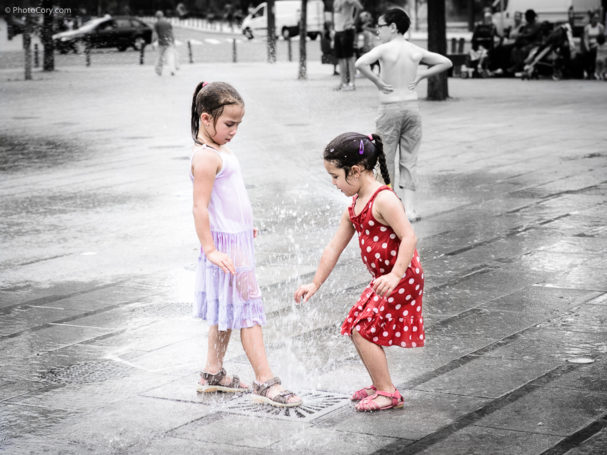 children wet in water fountain