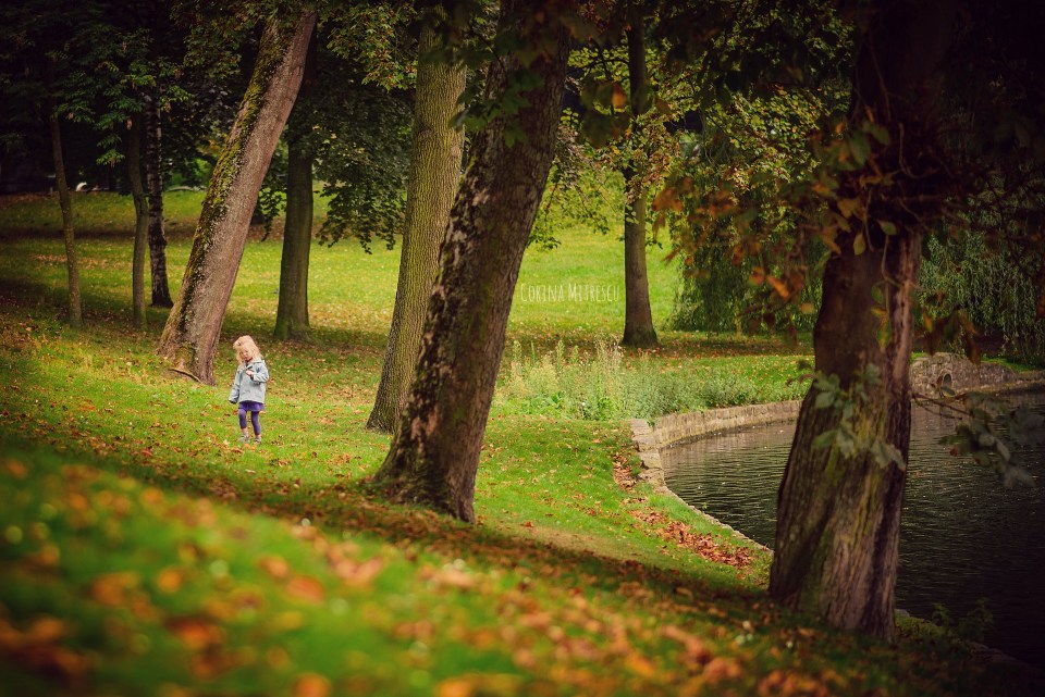little girl in forest lake trees