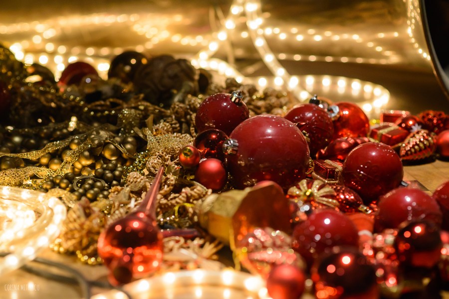 red christmas globes and yellow lights in window display